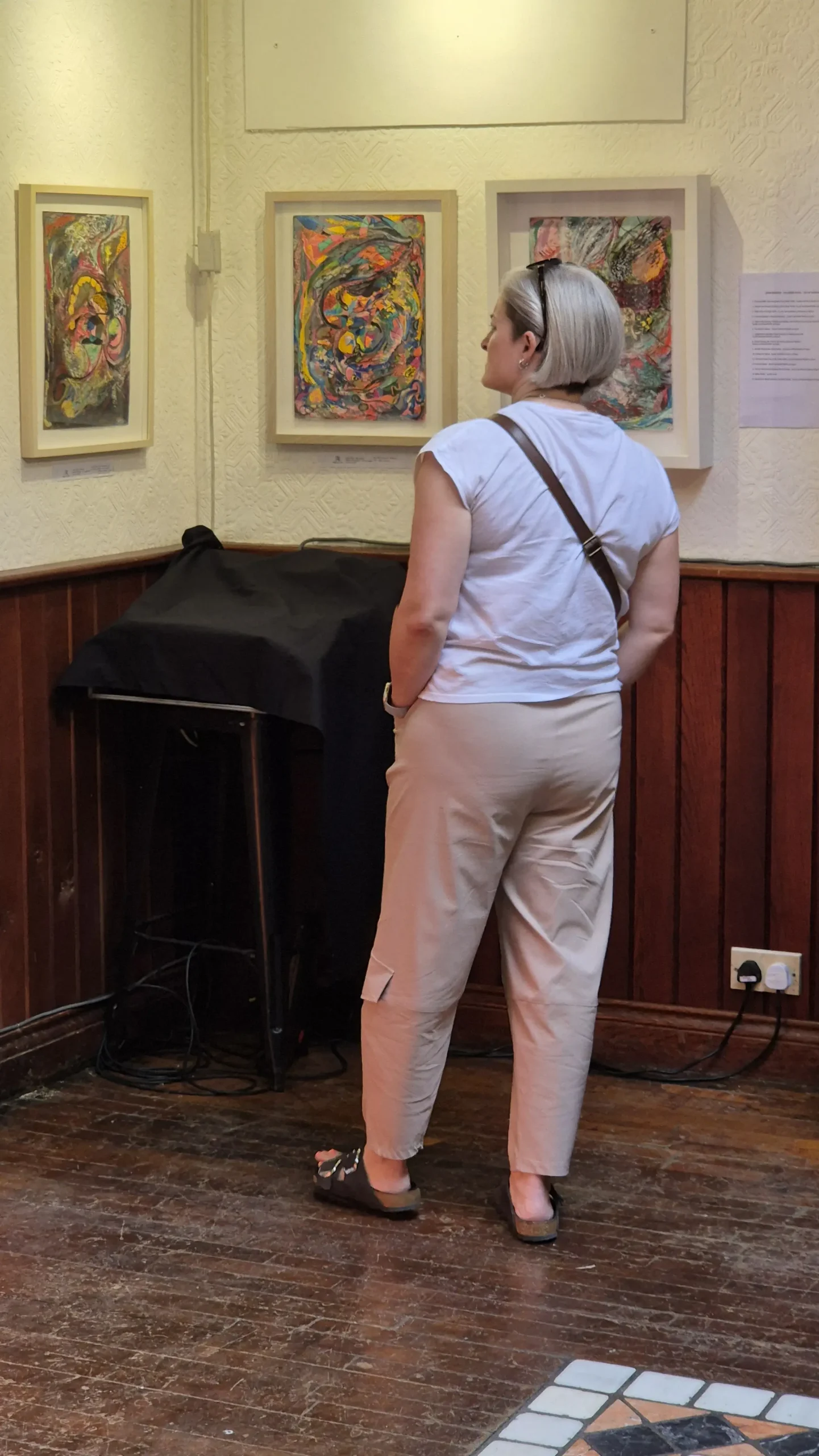A woman looks at artwork