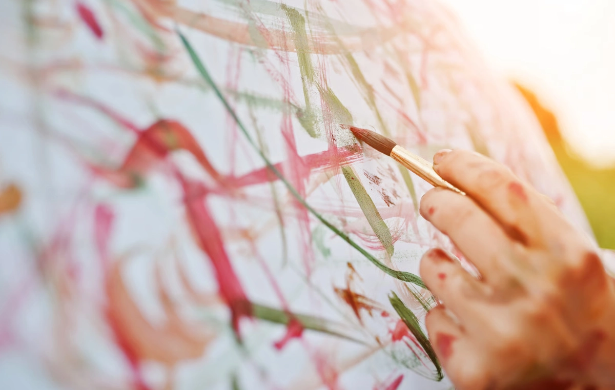 Someone painting on a canvas